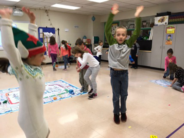 Students in multi-purpose room playing Skillastics during After School  Program