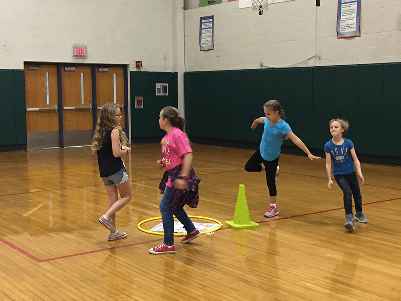 students physically active running around Skillastics Miniature mat on gym  Floor