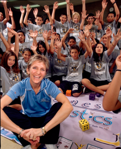 Skillastics CEO, Sandy Slade in front of Happy Physical Education Students