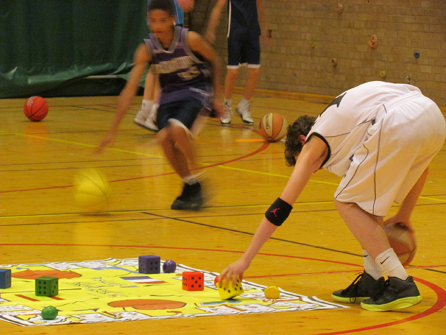 Students playing Basketball Skillastics on gym floor