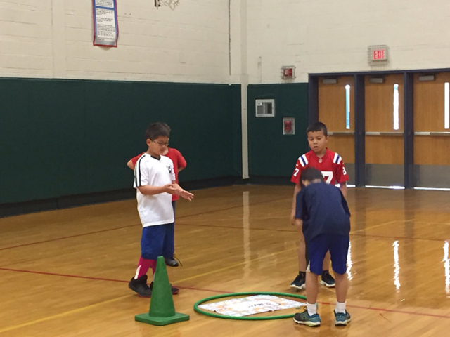 Students surrounding Skillastics miniature mat exercising.