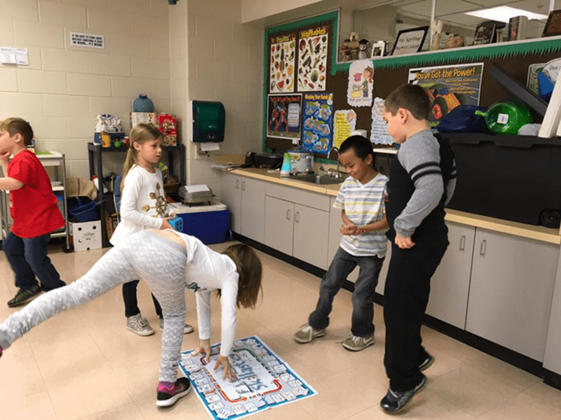 Students in multi-purpose room playing Skillastics during After School Program