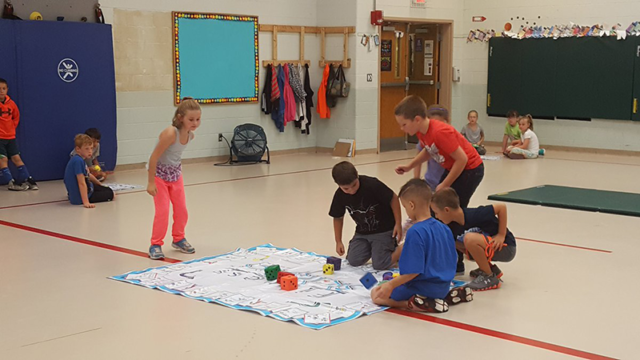 Students in multi-purpose room playing Skillastics during After School Program