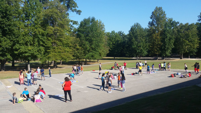 Large Group of Students outdoors exercising and playing Skillastics