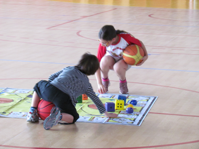 Students rolling die on oversize Basketball Skillastics mat