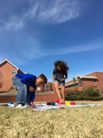 Boy & Girl exercising and playing Skillastics outside during After School Program