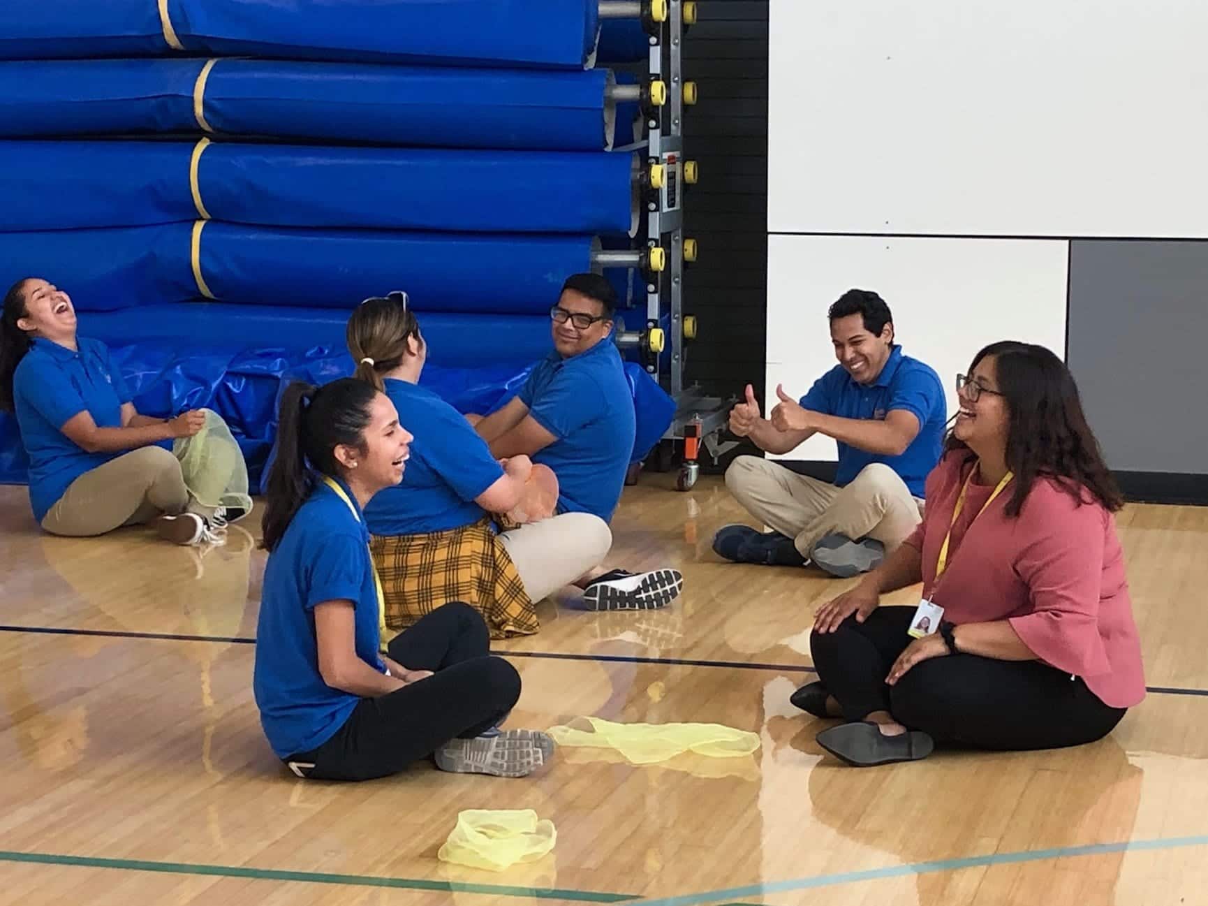 After School instructors practicing sitting, and tossing activity scarf during Professional Development Training.