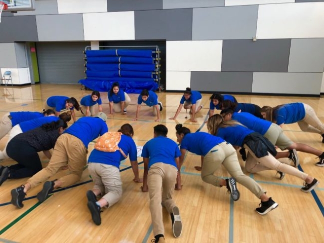 After School instructors participating in a fitness activity during Professional Development Training.