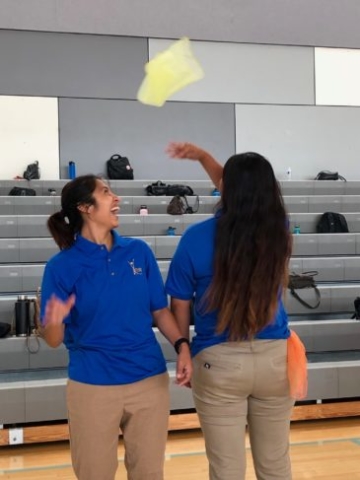 After School instructors practicing tossing activity scarf during Professional Development Training.