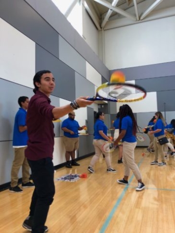After School Instructor practicing Tennis during Professional Development Training.