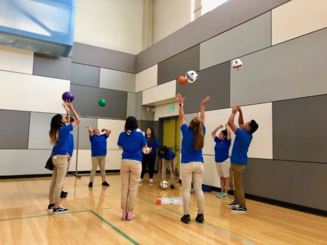 After School Instructors practicing volleyball during Professional development Training.