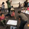 Group of multi-racial children moving around and having fun using the Fitness skillastics activity kit.
