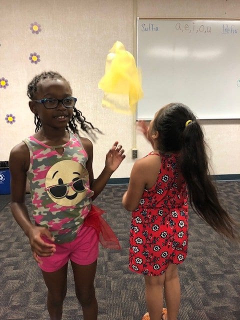 Children tossing the lightweight scarves during an activity session.